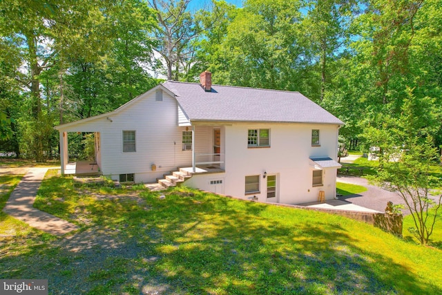 back of house featuring cooling unit and a yard