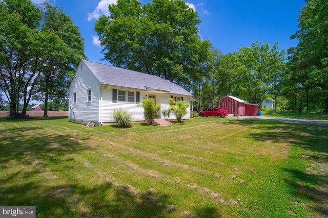 5709 Plummer Ln, Lothian, MD 20711 - view of front facade featuring a front yard, an outbuilding, and a detached garage