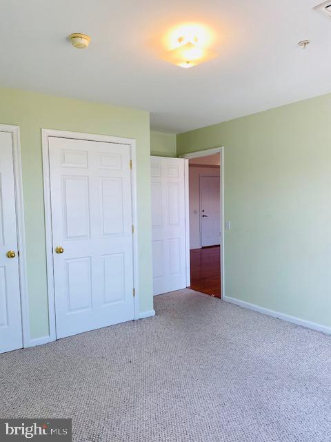 unfurnished bedroom featuring carpet and a closet