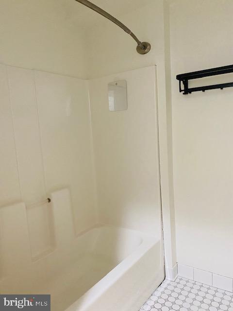 bathroom with bathing tub / shower combination