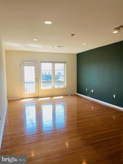 unfurnished room with light hardwood / wood-style floors