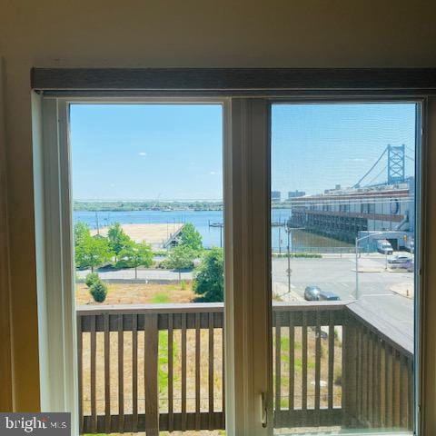 doorway to outside with a water view and a wealth of natural light