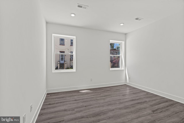 unfurnished room with dark hardwood / wood-style flooring