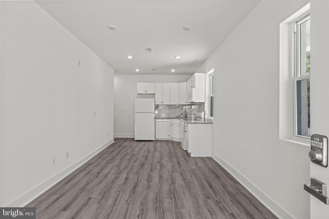 unfurnished living room featuring hardwood / wood-style flooring