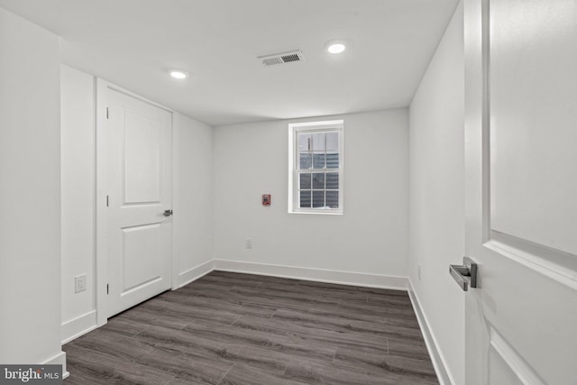 empty room with dark wood-type flooring