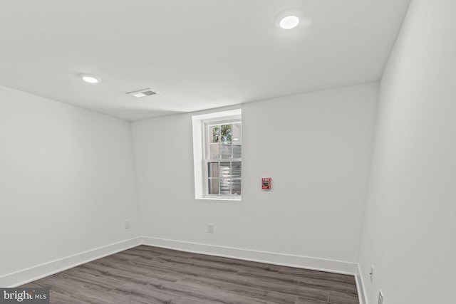 spare room with dark hardwood / wood-style floors