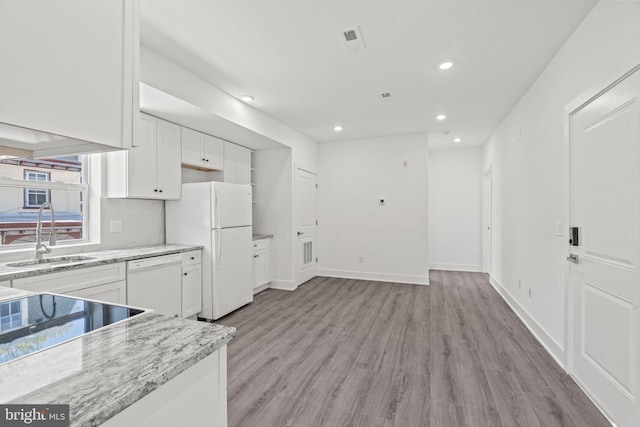 kitchen featuring white appliances, sink, light hardwood / wood-style floors, and white cabinets