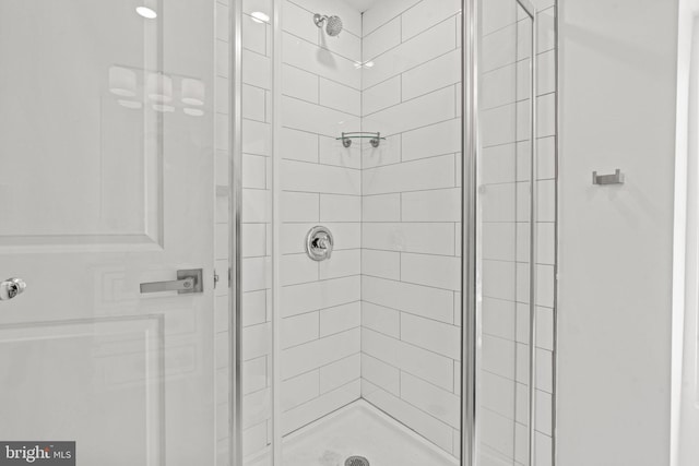 bathroom with a shower with door