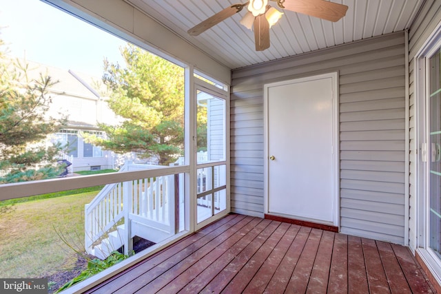 unfurnished sunroom with ceiling fan