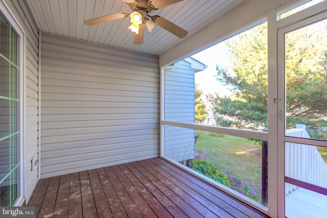 unfurnished sunroom featuring wooden ceiling and ceiling fan