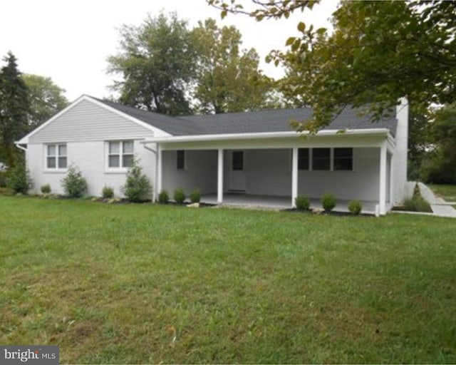 view of front facade featuring a front yard and a patio area