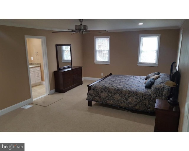 bedroom with crown molding, ensuite bathroom, carpet floors, and ceiling fan