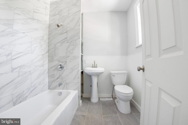 full bathroom featuring tiled shower / bath, sink, tile flooring, and toilet