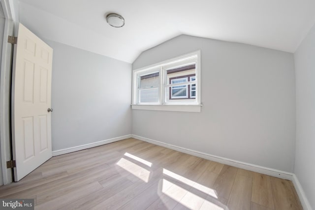 bonus room with vaulted ceiling and light hardwood / wood-style flooring