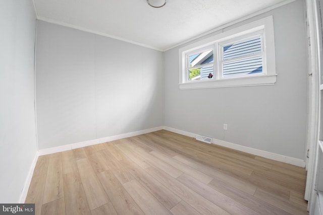 unfurnished room with light hardwood / wood-style floors and crown molding