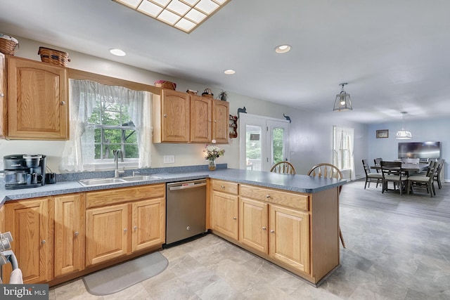 kitchen with dishwasher, french doors, hanging light fixtures, sink, and kitchen peninsula