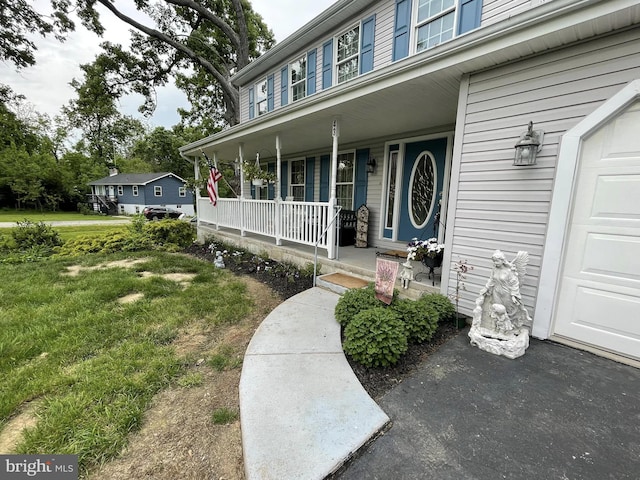 view of exterior entry with a yard