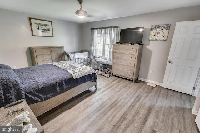 bedroom with ceiling fan and light hardwood / wood-style floors