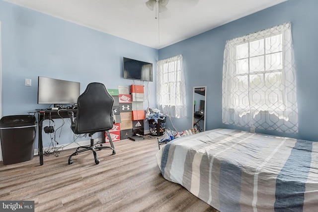 bedroom with wood-type flooring and ceiling fan