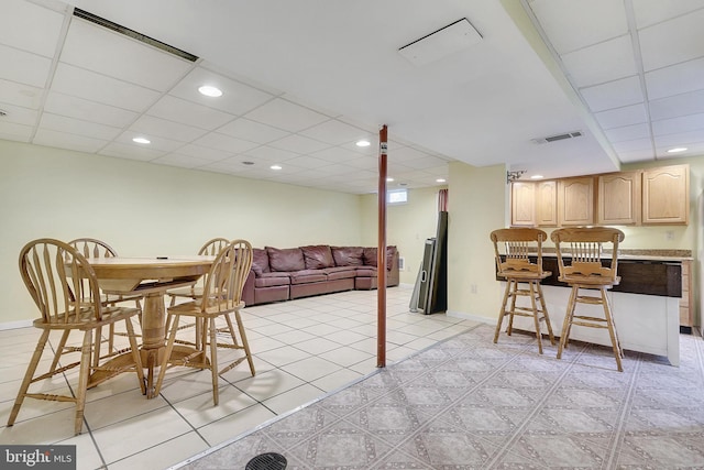 dining area with a paneled ceiling