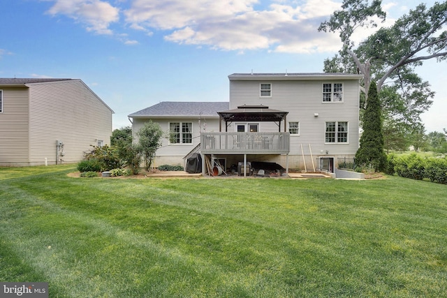 rear view of property with a gazebo, a yard, and a wooden deck