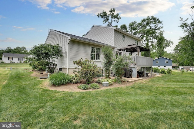 view of side of property featuring a deck and a yard