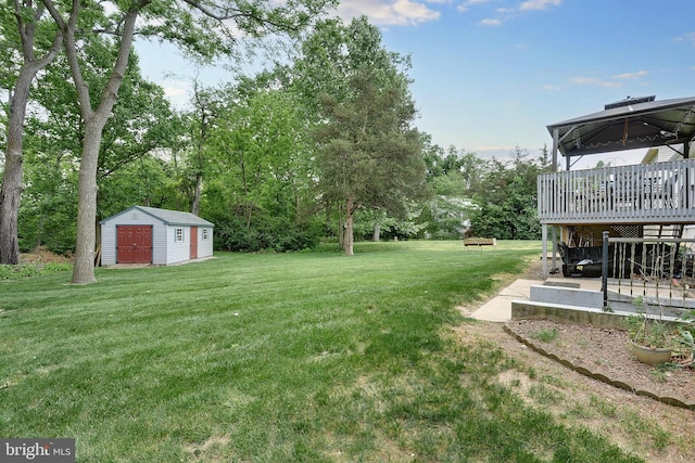 view of yard with a shed and a wooden deck