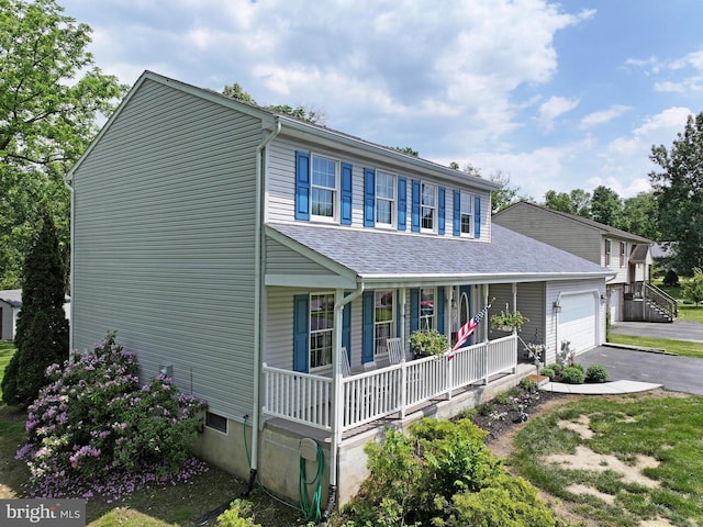 view of front of home featuring covered porch and a garage