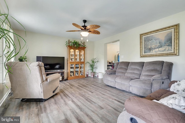 living room with hardwood / wood-style floors and ceiling fan