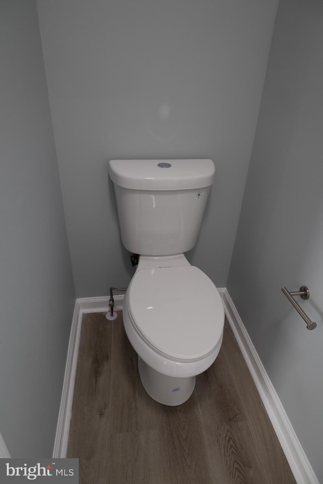 bathroom featuring wood-type flooring and toilet