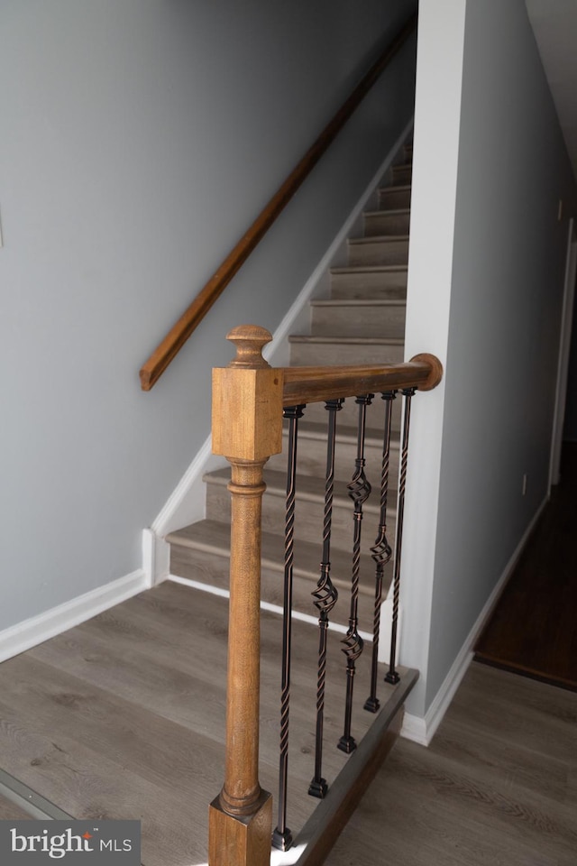 stairs featuring dark hardwood / wood-style flooring