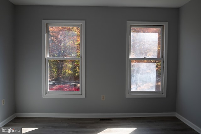 unfurnished room with dark hardwood / wood-style floors