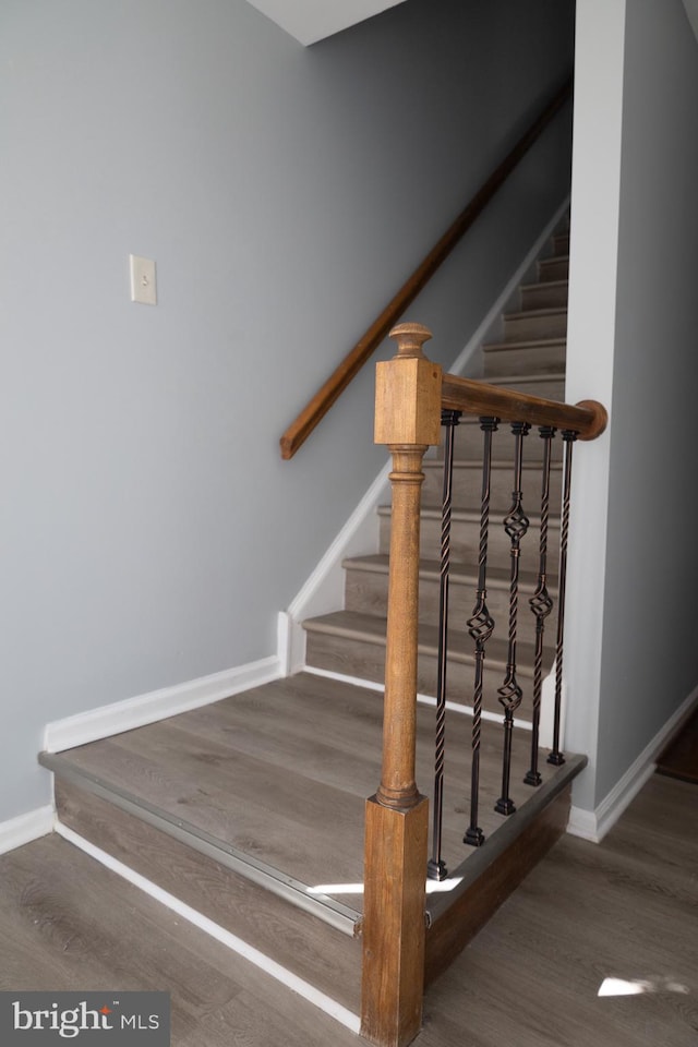 stairs with hardwood / wood-style floors