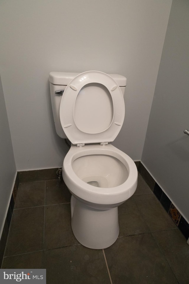 bathroom with tile floors and toilet