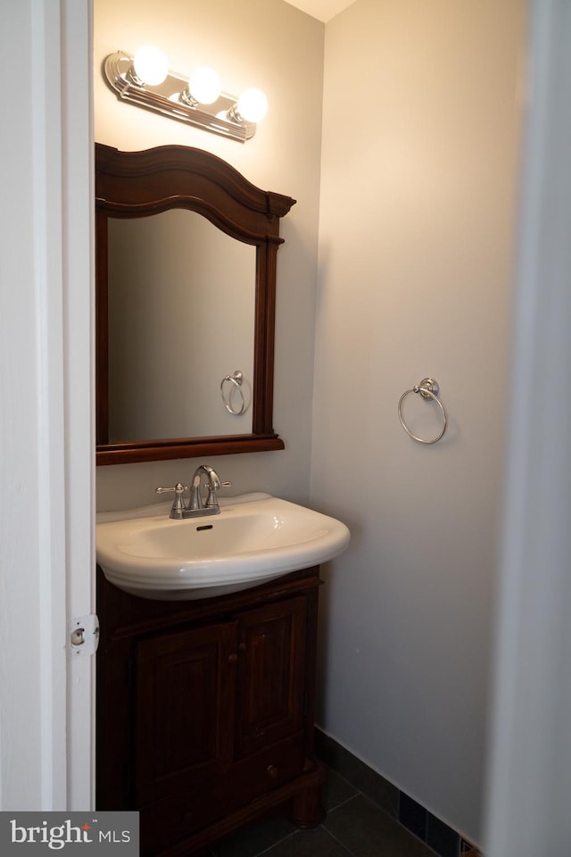 bathroom with tile floors and vanity with extensive cabinet space