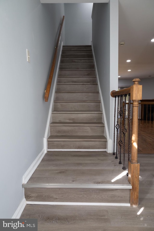 stairs featuring hardwood / wood-style flooring