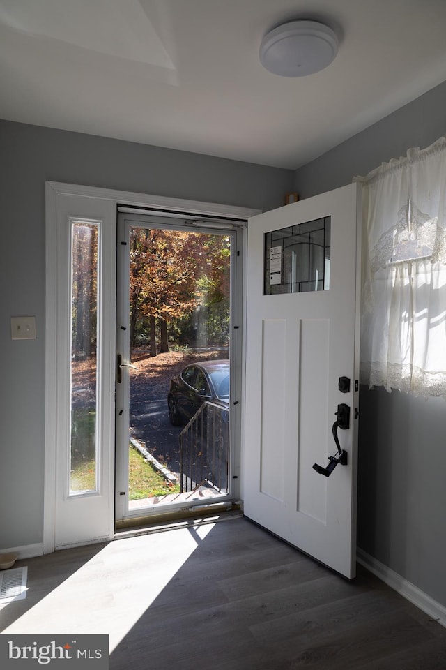 entryway with dark hardwood / wood-style floors