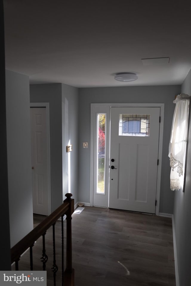 entryway with dark hardwood / wood-style floors