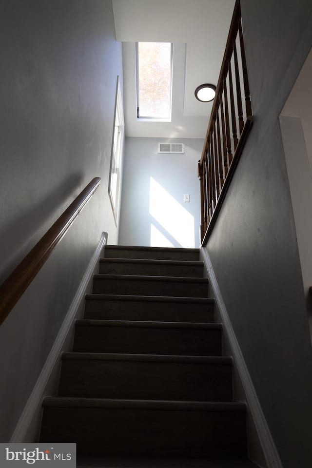 staircase featuring a high ceiling