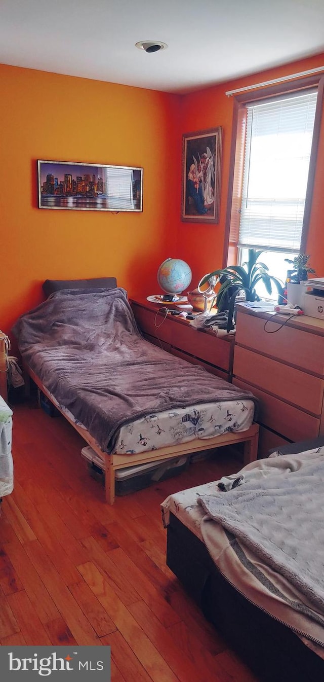 bedroom with wood-type flooring