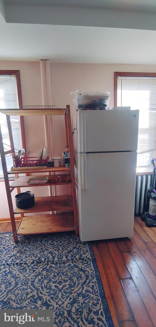 interior space with hardwood / wood-style floors and white fridge