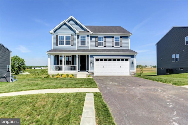 view of front facade with a garage, a front yard, and covered porch