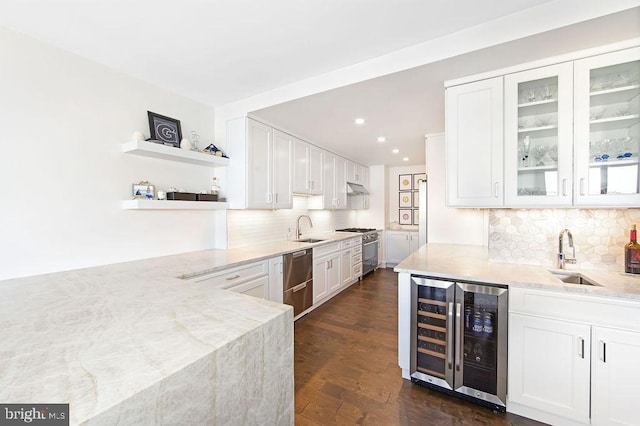 kitchen with white cabinetry, sink, stainless steel appliances, beverage cooler, and dark hardwood / wood-style floors