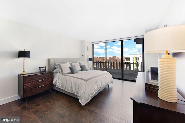 bedroom with access to exterior, floor to ceiling windows, and dark hardwood / wood-style floors