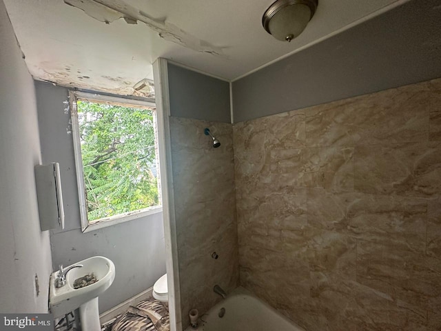 full bathroom featuring sink, toilet, and tiled shower / bath