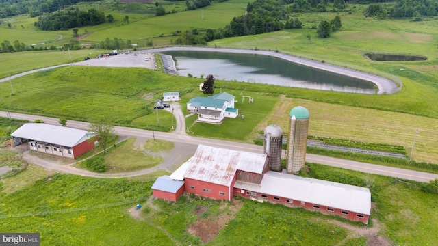 birds eye view of property with a rural view and a water view