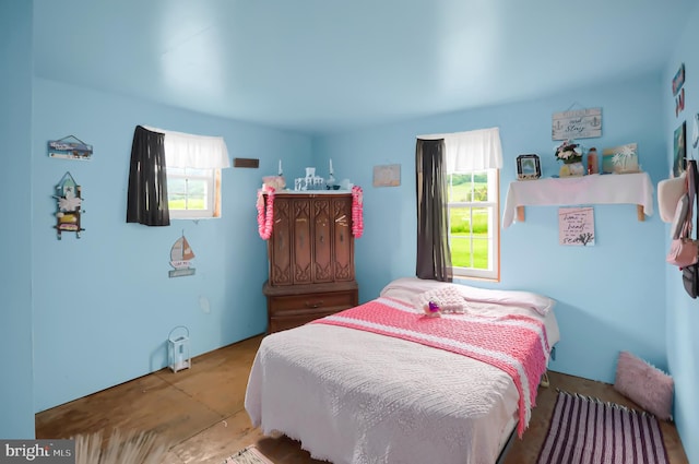 tiled bedroom with multiple windows