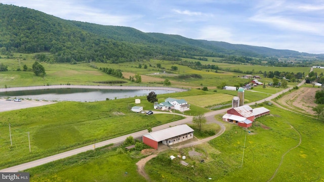 drone / aerial view featuring a rural view and a water and mountain view