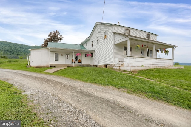 view of front of home with a front yard and a porch