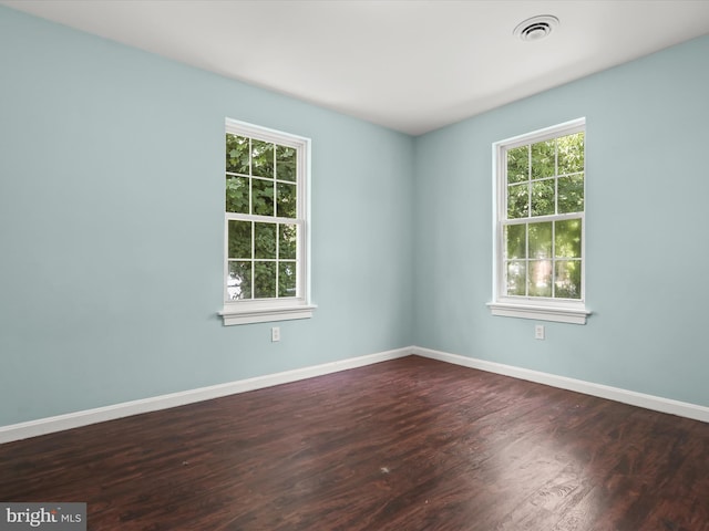 unfurnished room with dark wood-type flooring